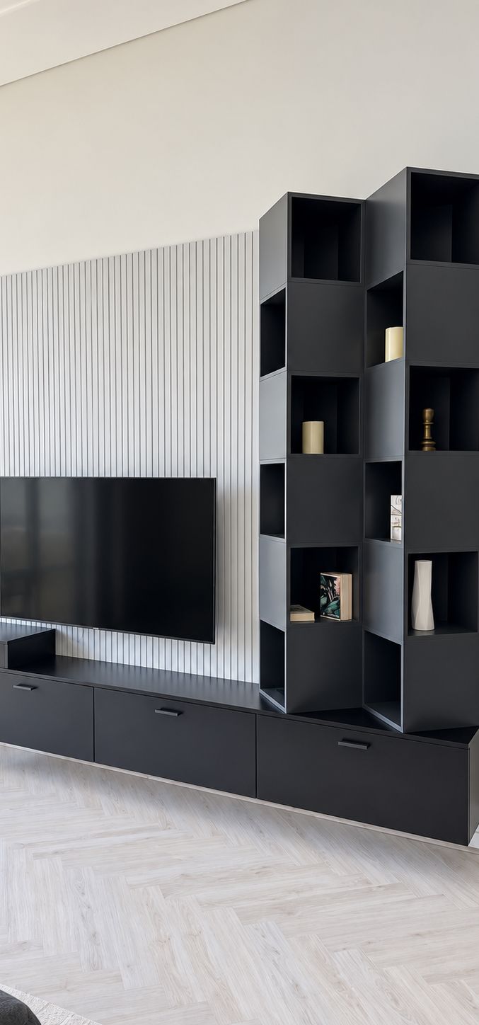 Black TV unit with slatted panel and stacked open shelving