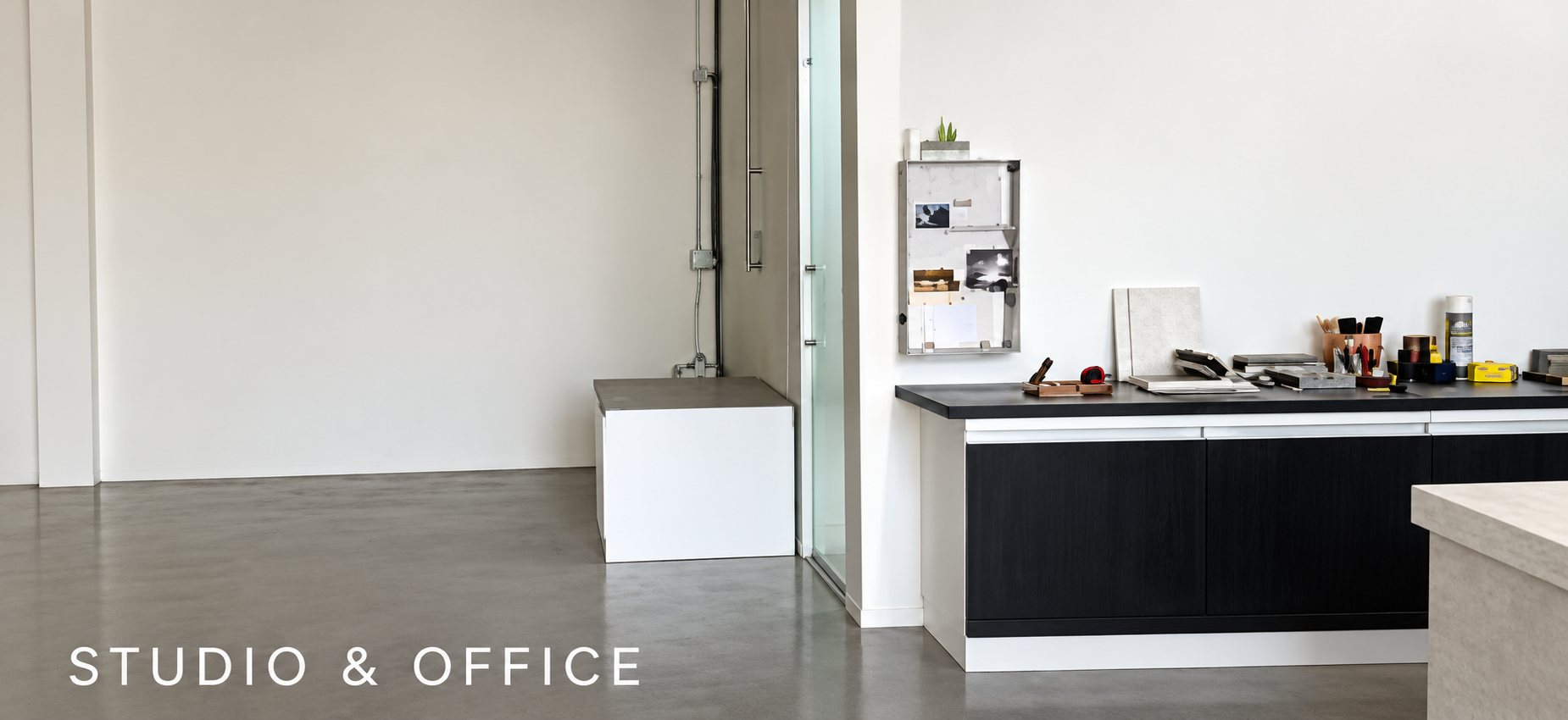 Bright studio and office space with a black kitchen unit