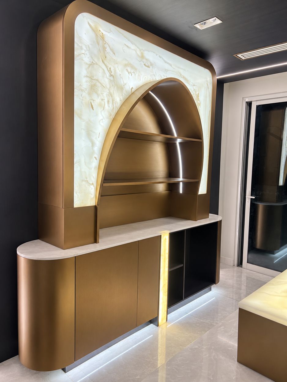 Bronze-finish arched bar unit with backlit onyx panel and curved ends