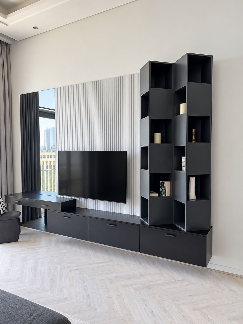 Black wall-hung TV unit with slatted panel and staggered open shelving