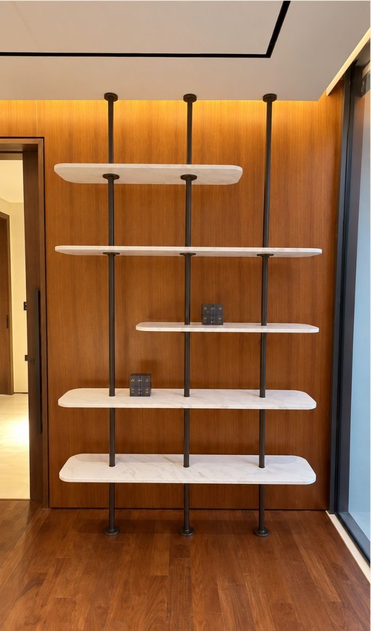 Post shelving with marble-effect shelves against a veneer wall